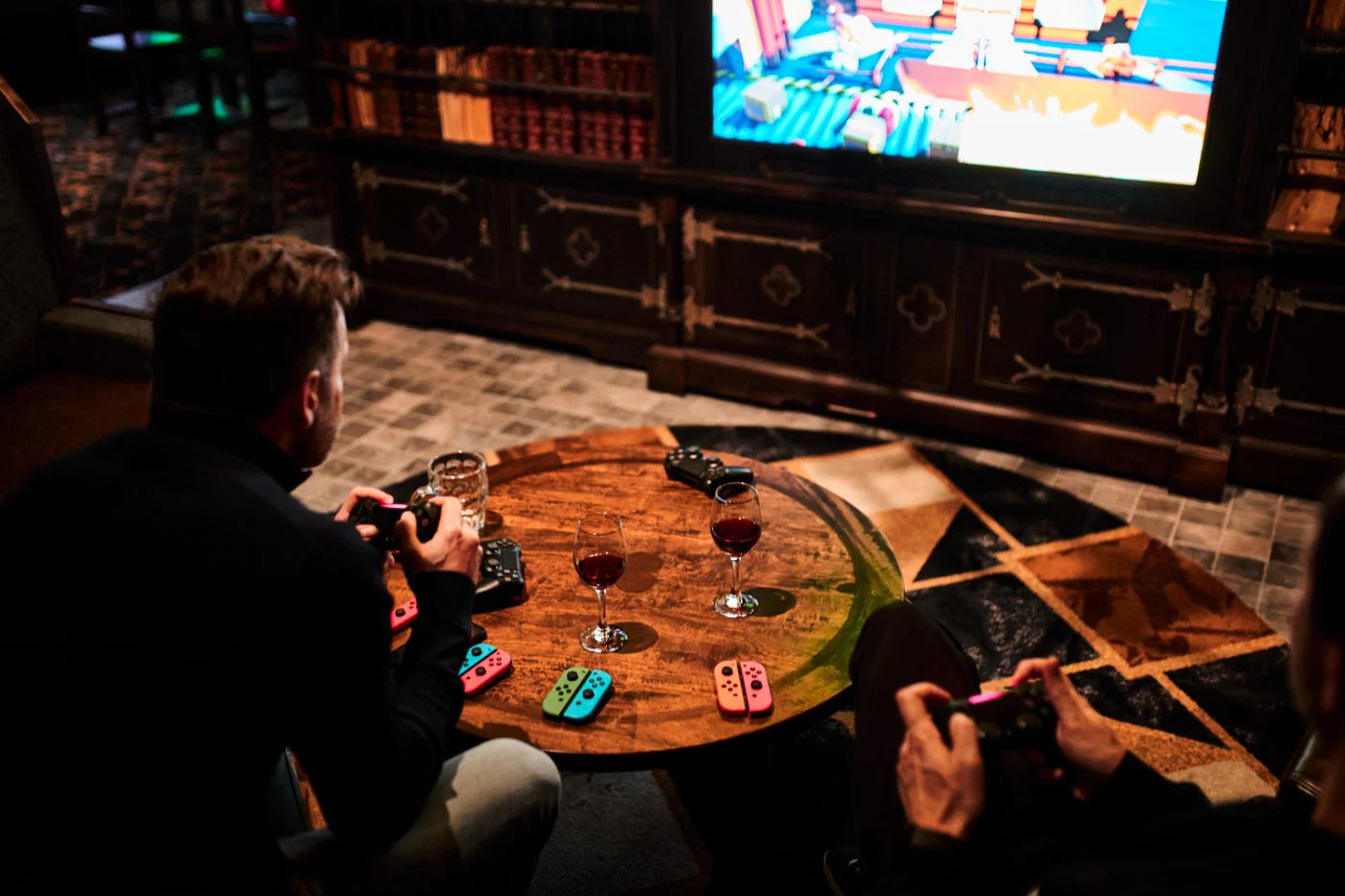 Guests laughing on the lounge couch with wireless controllers